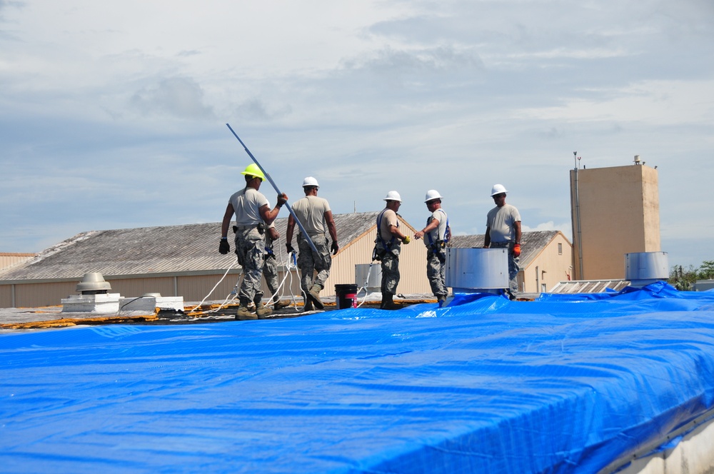 156th Civil Engineering Squadron repair roof with FEMA blue sheets