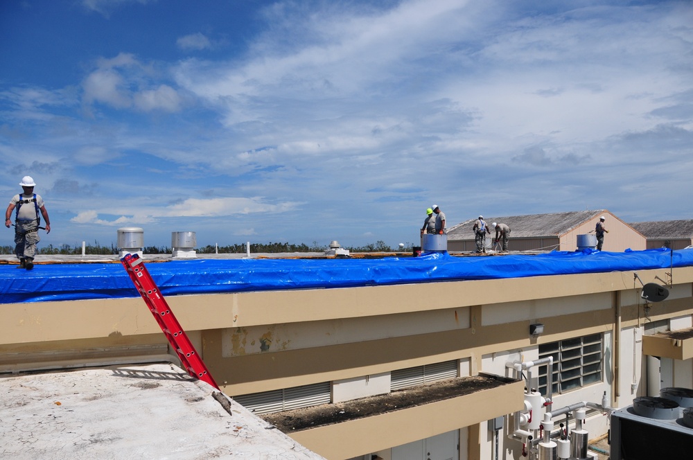 156th Civil Engineering Squadron repair roof with FEMA blue sheets