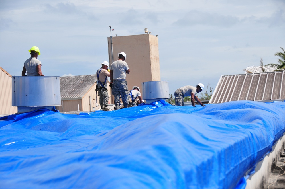 156th Civil Engineering Squadron repair roof with FEMA blue sheets