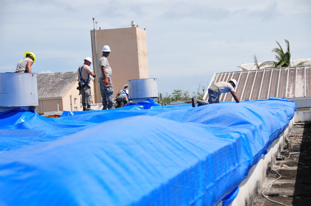 156th Civil Engineering Squadron repair roof with FEMA blue sheets