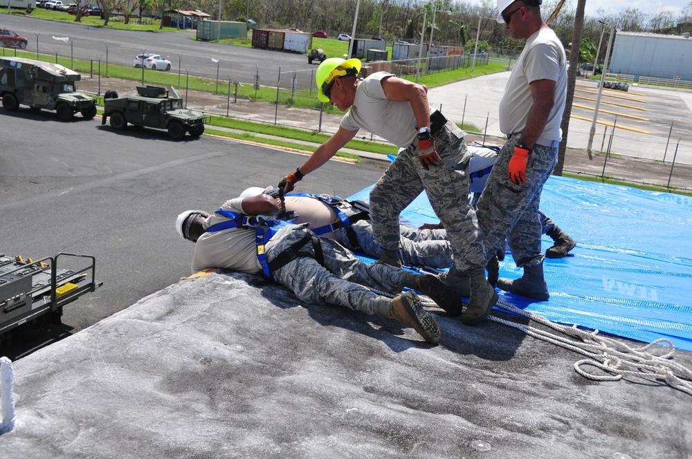 156th Civil Engineering Squadron repair roof with FEMA blue sheets