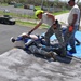 156th Civil Engineering Squadron repair roof with FEMA blue sheets