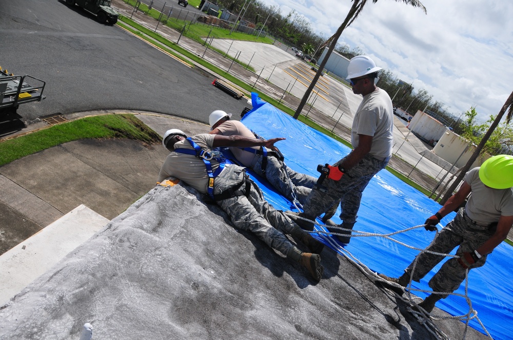 156th Civil Engineering Squadron repair roof with FEMA blue sheets