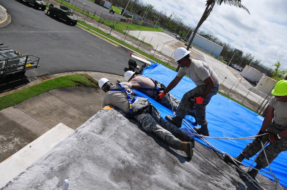 156th Civil Engineering Squadron repair roof with FEMA blue sheets