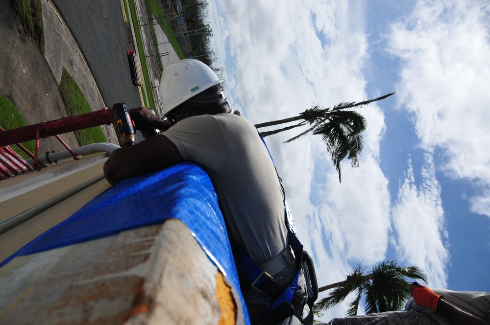 156th Civil Engineering Squadron repair roof with FEMA blue sheets