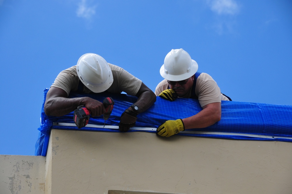 156th Civil Engineering Squadron repair roof with FEMA blue sheets