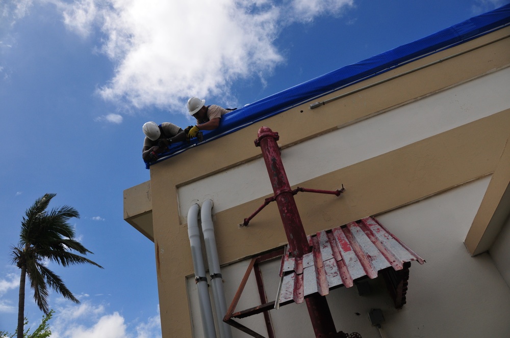 156th Civil Engineering Squadron repair roof with FEMA blue sheets