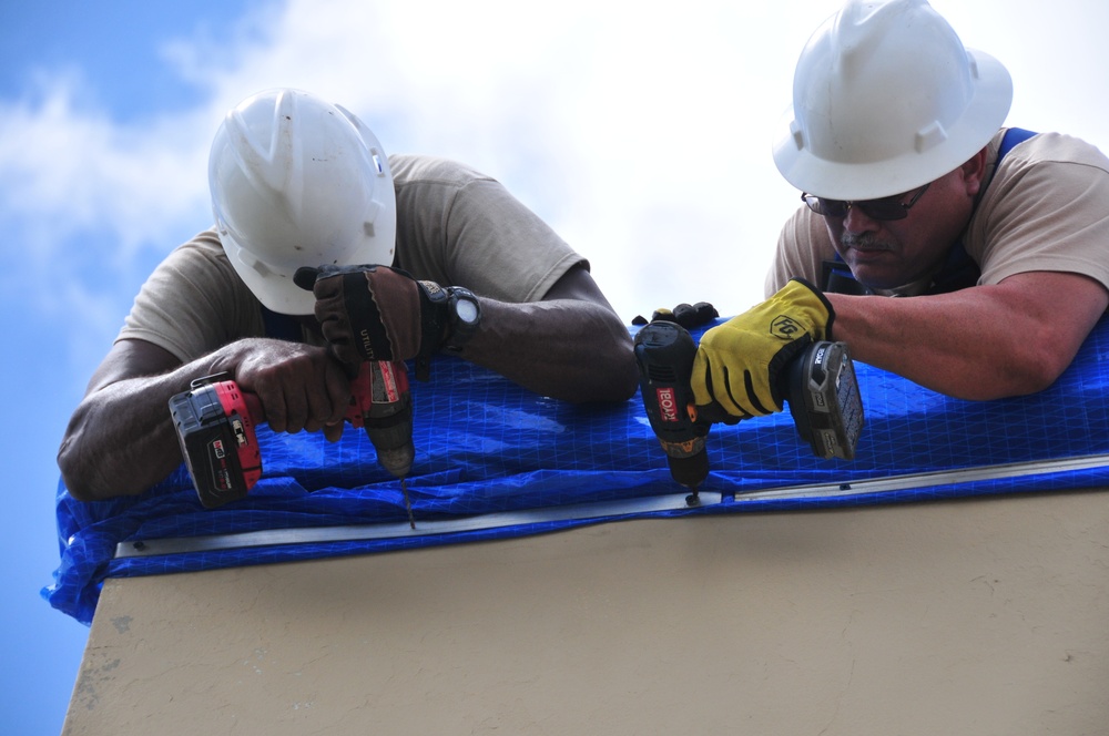 156th Civil Engineering Squadron repair roof with FEMA blue sheets