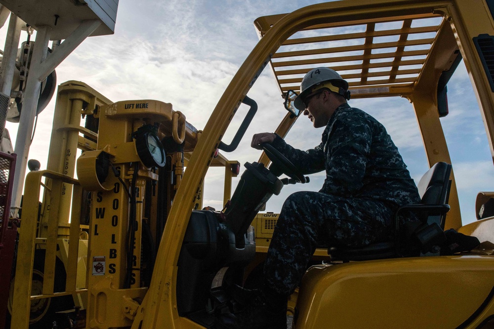 Sailor Operates Forklift