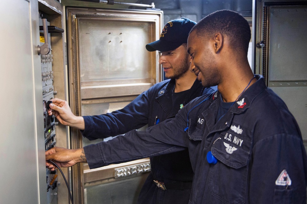 USS America Electronics Technician conducts maintenance checks