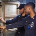 USS America Electronics Technician conducts maintenance checks