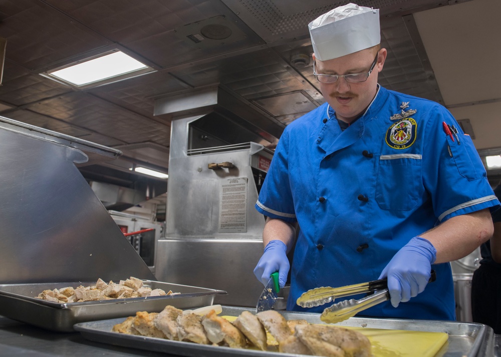 USS Lake Erie (CG 70) CS2 prepares a meal for the crew