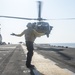 USS America Sailor signals helicopter
