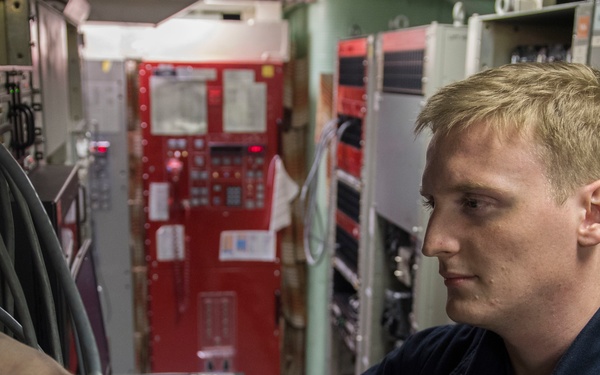 USS Lake Erie (CG 70) IT3 troubleshoots in radio central