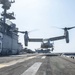 USS America Sailor signals MV-22 Osprey lift off