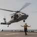 USS America Sailor guides aircraft to land