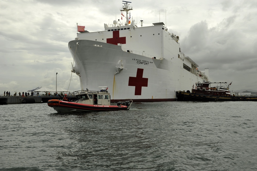 Coast Guard crewmembers escort the USNS Comfort into San Juan, Puerto Rico