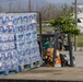 Militia Member Loads Water onto Truck