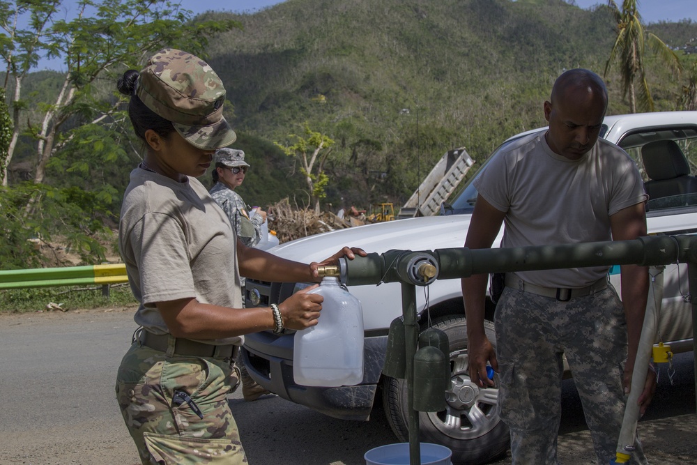 Soldiers Fill Water Containers for Resident