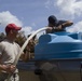 Airman Helps Resident Fill Water Tank