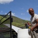 Soldier Fills Water Tank for Resident