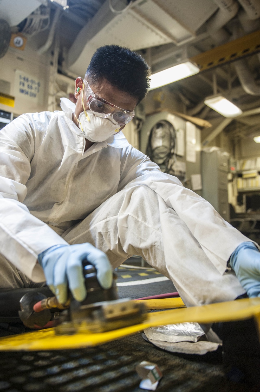 USS America Sailors sand down forklift