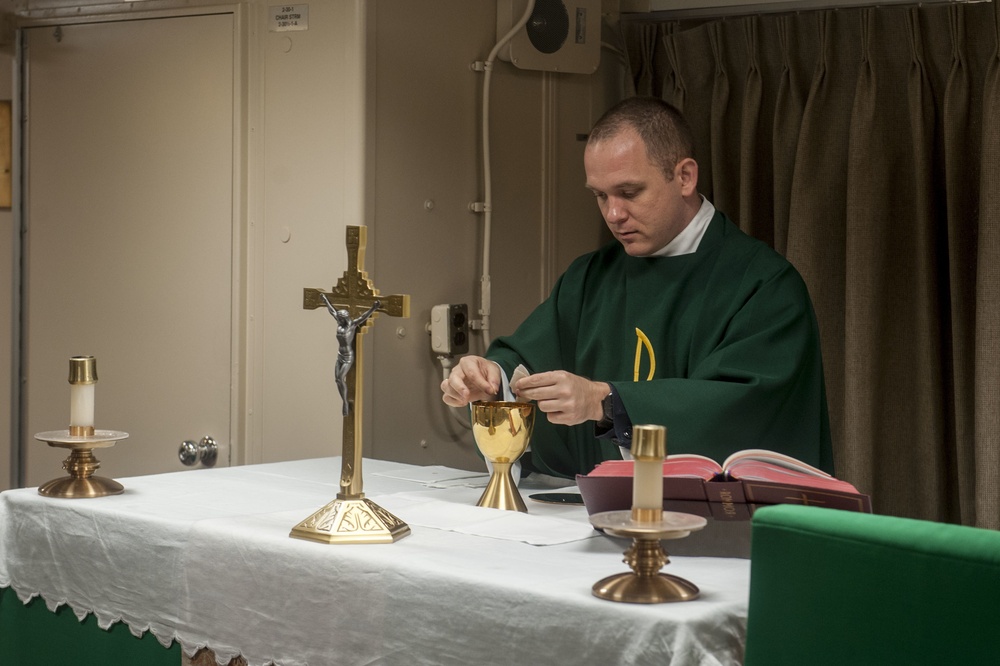 USS America Sailor holds morning mass