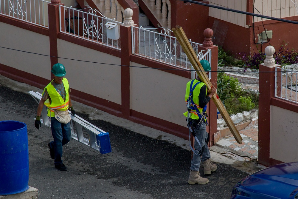 Contractors Carry Equipment