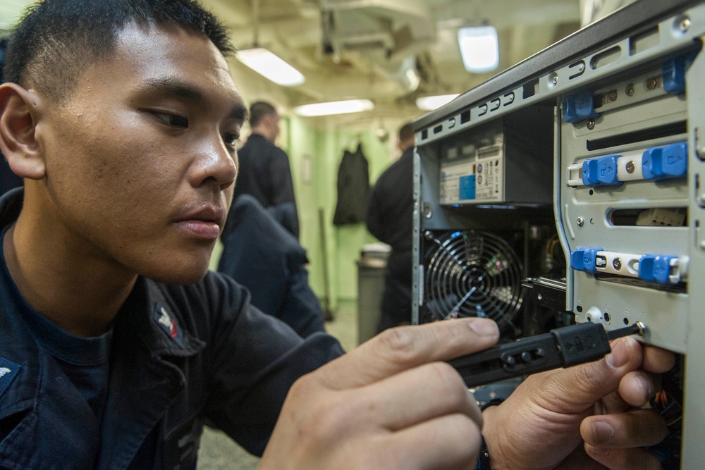 USS America Sailor installs hard drive