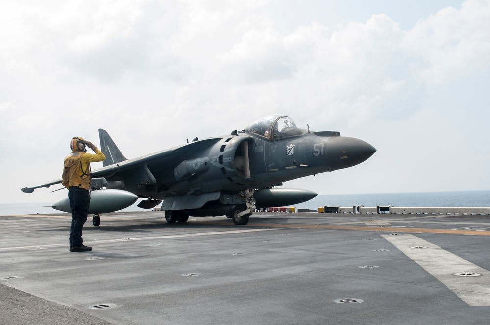 USS America Sailors salutes aircraft before lift off