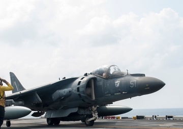 USS America Sailors salutes aircraft before lift off