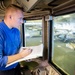 USS America Sailor stands hangar bay watch