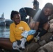 USS Bonhomme Richard (LHD 6) Sailors participate in base waterfront clean up