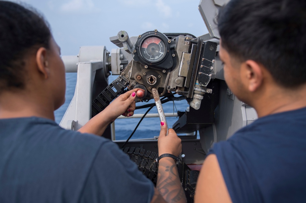 USS Lake Erie (CG 70) Gunner's Mates conduct maintenance on a MK 38