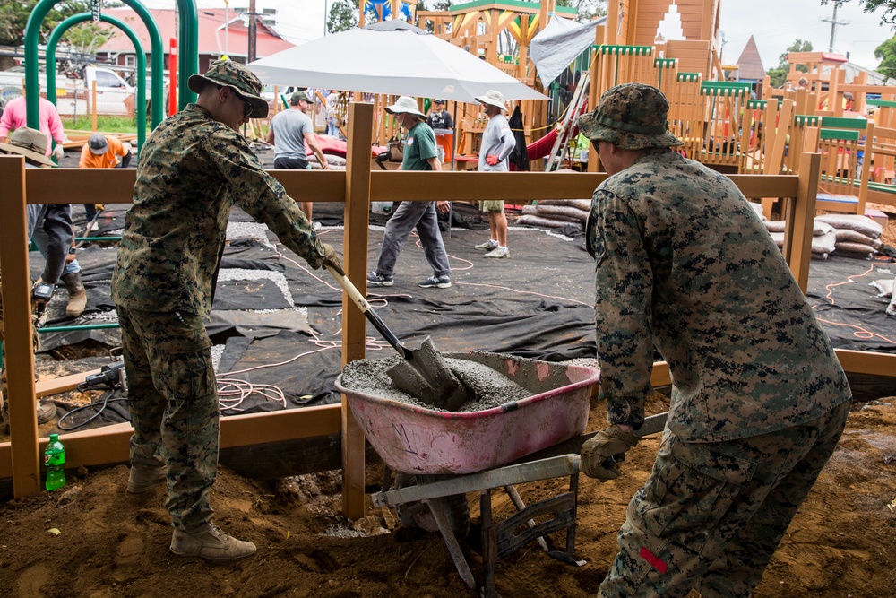 U.S. Marines with Combat Logistics Battalion 3 help build community playground