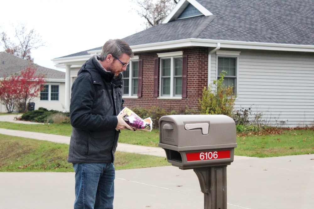 Safety personnel deliver Halloween treat bags to Fort McCoy families