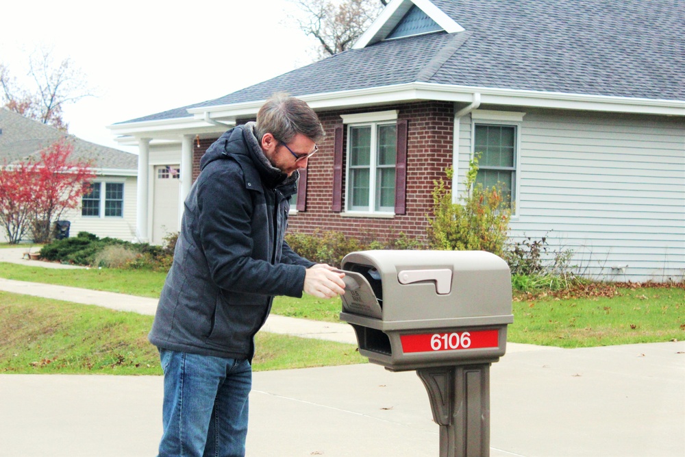 Safety personnel deliver Halloween treat bags to Fort McCoy families