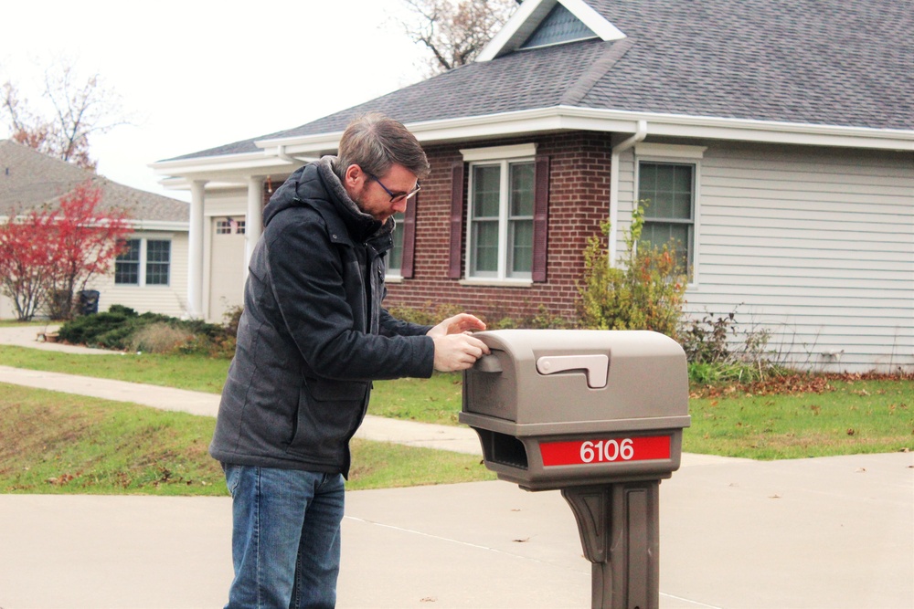 Safety personnel deliver Halloween treat bags to Fort McCoy families