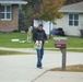 Safety personnel deliver Halloween treat bags to Fort McCoy families