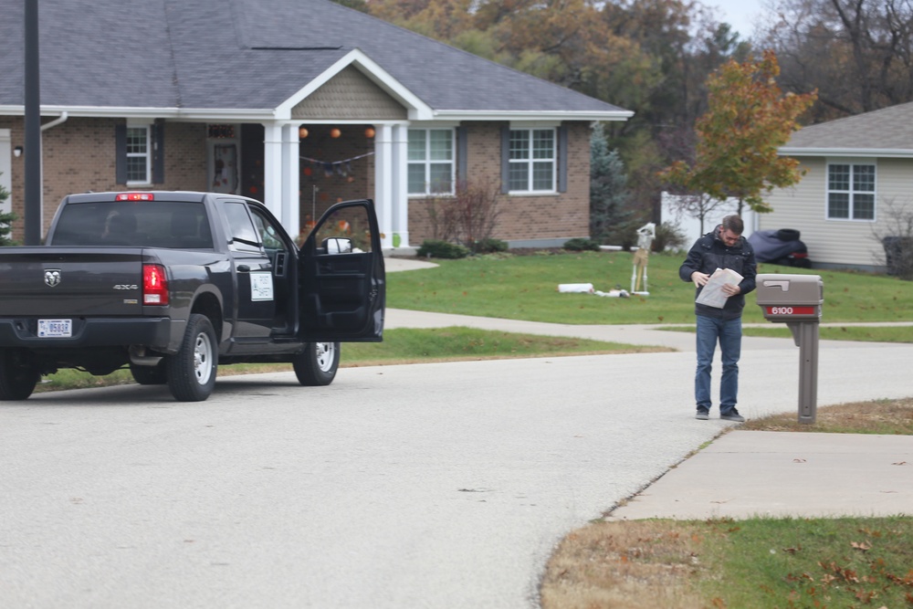 Safety personnel deliver Halloween treat bags to Fort McCoy families