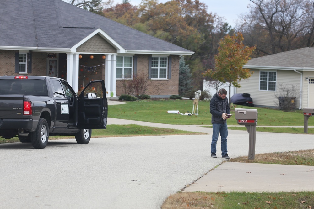 Safety personnel deliver Halloween treat bags to Fort McCoy families