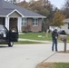 Safety personnel deliver Halloween treat bags to Fort McCoy families