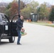 Safety personnel deliver Halloween treat bags to Fort McCoy families