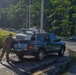 Soldier Loads Water Jugs into Pickup