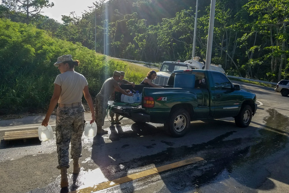 Soldiers Load Water Jugs