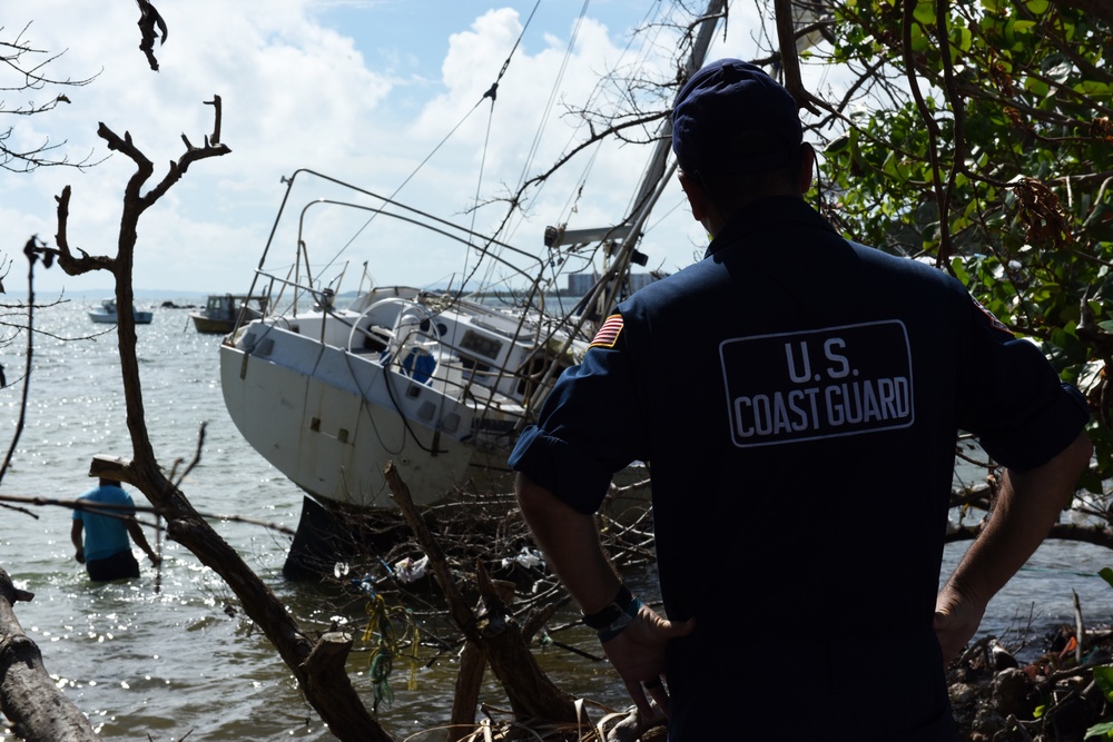 Maria ESF-10 PR Unified Command responders attach notification decals on damaged and derelict vessels in Puerto Rico