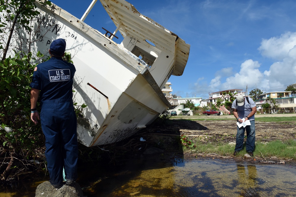 Maria ESF-10 PR Unified Command responders attach notification decals on damaged and derelict vessels in Puerto Rico
