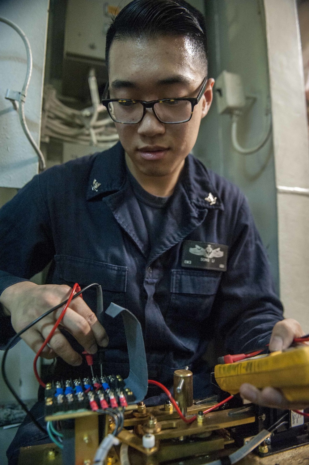 USS America Sailor conducts maintenance on limit switch