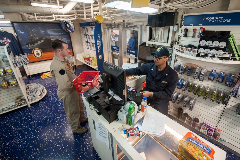 USS America Sailor sells products at ship’s store