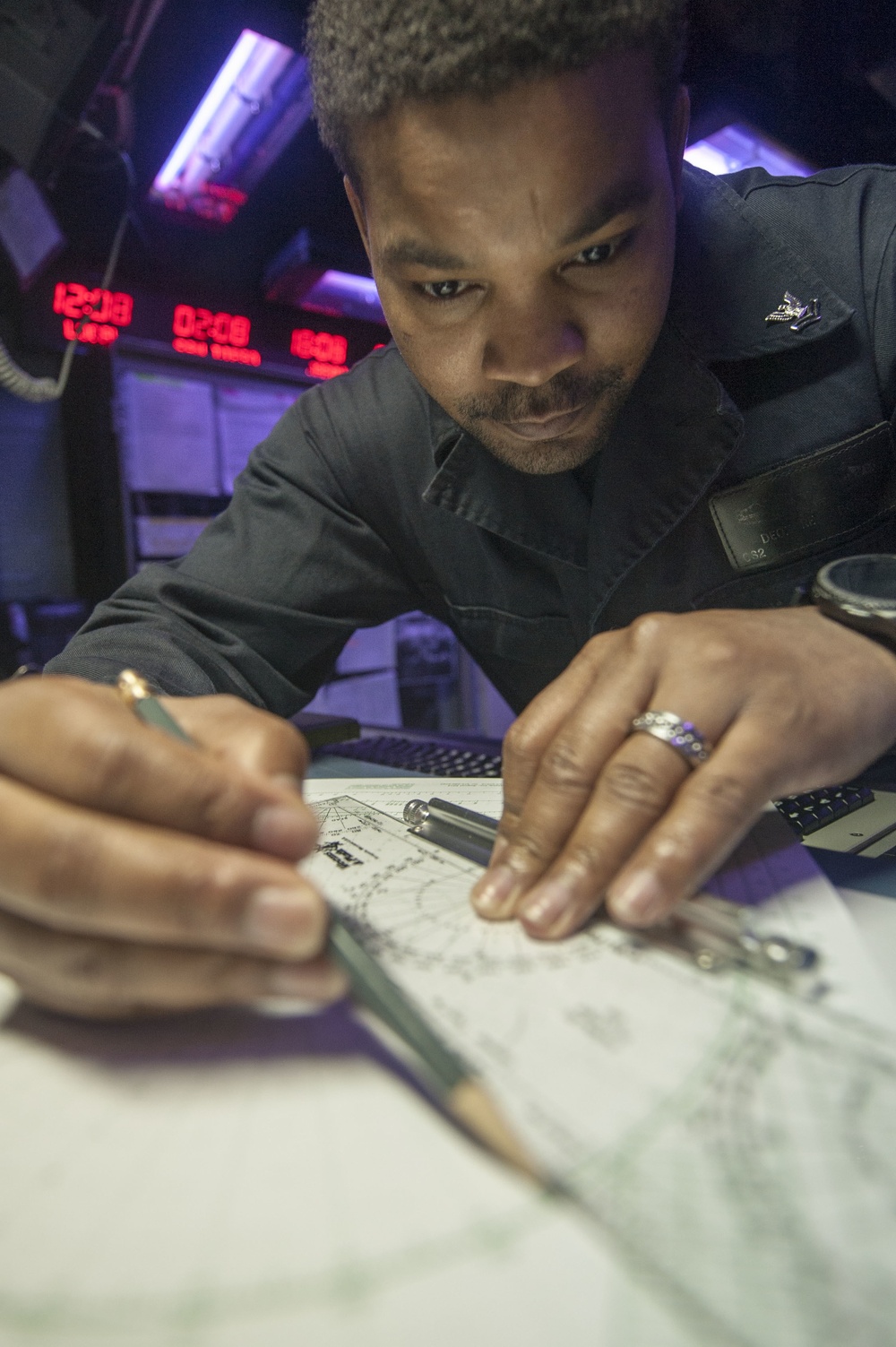 USS America Sailor charts maneuvering board